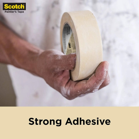 Person holding Contractor Grade Masking Tape That Sticks Like A Pro 0.94 Inch By 60.1 Yards Per Roll 9 Rolls High Adhesion Painter Tape