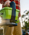 Person using 20-Volt Cordless Handheld Seed And Fertilizer Spreader For Yard Work With Adjustable Spreading Rate Dial outdoors