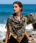 Woman wearing a 43 Inch Square Silk Feeling Scarf For Hair And Neck Wrap, Lightweight Satin Polyester Blend, 110cm By 110cm, Versatile Fashion Accessory by the sea