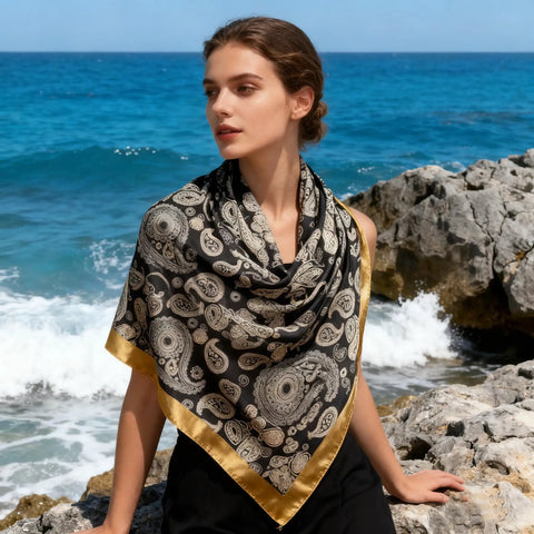 Woman wearing a 43 Inch Square Silk Feeling Scarf For Hair And Neck Wrap, Lightweight Satin Polyester Blend, 110cm By 110cm, Versatile Fashion Accessory by the sea
