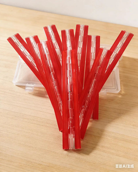 Twelve Inch Clear Acrylic Self Adhesive Piano Hinges Ten Pack, red strips displayed on a wooden surface, suitable for garage doors.