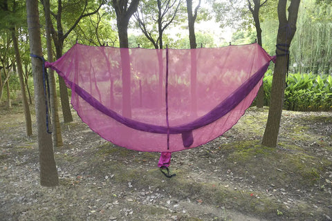 Premium Hammock Mosquito Net For Camping That Breathes Easy And Keeps Bugs Out tied between trees outdoors