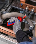 Technician using stripping knife with sliding shoe and ratchet function for tough plastic sheaths up to 7 mm wall thickness