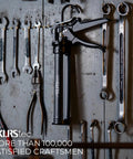 Heavy Duty Caulking Gun With Twenty Five To One Thrust Ratio For Standard Ten Ounce 300ml Cartridges hanging on tool wall.