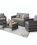 Four-Piece Outdoor Patio Furniture Set With Wicker Rattan Modular Sectional Sofa With Cozy Cushions And Glass Table All Weather Conversation Set For Garden Porch Backyard And Patio Light Gray shown on a rug