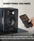 Person connecting a smartphone to Zero Latency Wired 4.5 Inch Studio Monitors And PC Speakers For Recording And Multimedia With Music Production Software, Crystal Clear Sound For Streaming, Gaming, Podcasts, And Studio Sessions with cable.