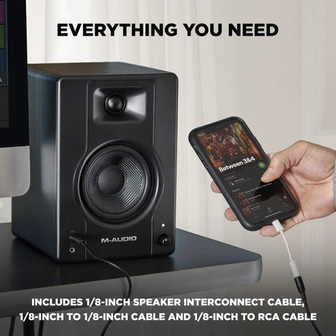 Person connecting a smartphone to Zero Latency Wired 4.5 Inch Studio Monitors And PC Speakers For Recording And Multimedia With Music Production Software, Crystal Clear Sound For Streaming, Gaming, Podcasts, And Studio Sessions with cable.