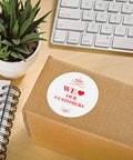 Round Printable Labels 300 Pack 2.5 Inch Matte White Stickers on a cardboard box with plant and stationery.