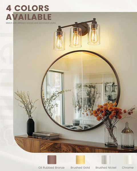 Three Light Vanity Light Fixture For Farmhouse Bathroom With Metal Wall Sconce Clear Glass Shades Oil Rubbed Bronze Finish E26 Base Socket LED Compatible Incandescent Friendly Durable Rustic Modern Look above a mirror.
