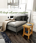 Bamboo Shower Bench With Storage Shelf For Indoor And Outdoor Use Sturdy Wooden Spa Bath Organizer Stool next to a sofa.