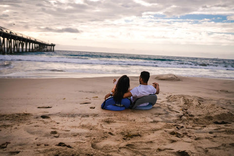 Couple sitting on sand using Go Anywhere Camping Chair With Padded Seat And Backrest Adjustable And Ultra Portable Lightweight Blue
