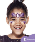 Top Shelf Fantasy Face Paint Palette Kit Featuring Skin Safe Cosmetics Grade Pigments With Smooth Metallic Sparkle Shades Includes Quick Dry Brush And Carry Case Killer For Halloween Festivals And Birthday Bash Body Art. Girl smiling with purple and gold face paint design.