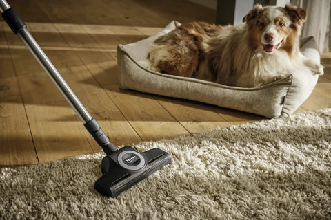 Turbo Floor Brush For Low To Medium Pile Carpets, Air Powered, shown on a carpet next to a dog, illustrating easy pet hair removal.