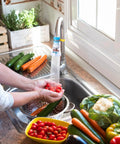 Person washing vegetables using 360 Rotating Faucet Filter Extenders Set For Sink Direct Water Flow And Splash Reduction