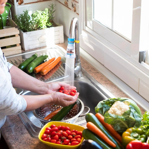 Person washing vegetables using 360 Rotating Faucet Filter Extenders Set For Sink Direct Water Flow And Splash Reduction