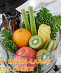 Kiamith 300W Cold Press Juicer With Huge 5.8 Inch Wide Feed Chute For Whole Produce, filled with fruits and greens.