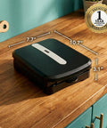 Ovente Two Serving Electric Indoor Grill And Panini Press Compact Contact Maker For Juicy Steaks Bold Smoky Flavor No Outdoor Mess Black Kitchen Appliance on wooden countertop, dimensions shown.
