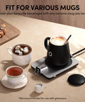 Level Up Your Morning Vibe This Smart Mug Warmer Game Changer Keeps Your Daily Brew Piping Hot With Precision Temp Control 15 Oz Ceramic Mugs Lids And Spoons Simple Cord Setup. Black ceramic mug on warmer with white mug and tea cup nearby.