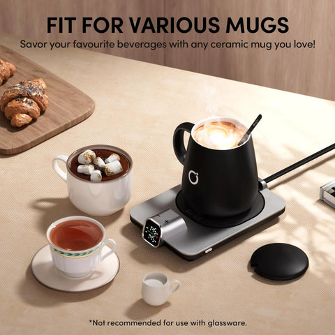 Level Up Your Morning Vibe This Smart Mug Warmer Game Changer Keeps Your Daily Brew Piping Hot With Precision Temp Control 15 Oz Ceramic Mugs Lids And Spoons Simple Cord Setup. Black ceramic mug on warmer with white mug and tea cup nearby.