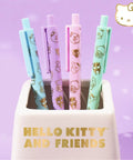 Kawaii Sanrio Pen Set With Four Color Ballpoint Pens Featuring My Melody And Kuromi Glitter Gold Foil Accents in a holder