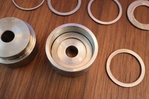 Coin Ring Puncher And Spacer Set For Jewelry Making With Six Spacer Rings In Inner Diameters On Wood Surface