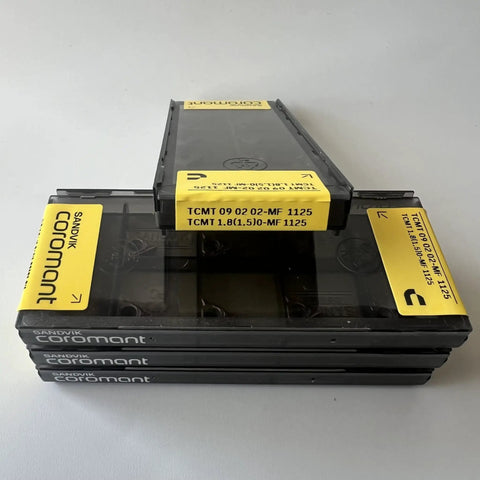 Box of Sandvik Coromant 1125 T Max P Turning Insert For CNC Lathes TCMT090202 MF Style, packaged in black and yellow.