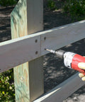 Drill inserting SDWS Exterior Timber Screws 0.220 Inch By 8 Inch With Sawtooth Point into outdoor wood fence post