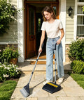 Heavy Duty Broom And Dustpan Set With Extended Handle For Fast Outdoor Cleanup in use by a woman on a stone path.