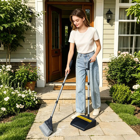 Heavy Duty Broom And Dustpan Set With Extended Handle For Fast Outdoor Cleanup in use by a woman on a stone path.