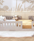 Full Size Wood Bed Frame With Safety Guardrail For Kids in natural pine with cozy play space, featuring stuffed toys and pillows.