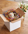 Pack Of 40 5x5x5 White Corrugated Shipping Boxes For Mailing And Packaging, open box with colorful shredded paper and mug