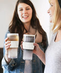 Two women holding Freezable Insulated Pint Mugs Set Of 2 Double Walled Frosty Drink Glasses With Gel Core 16 Oz marble tumblers.