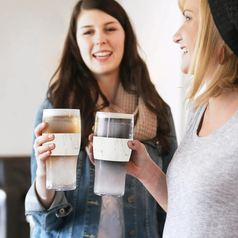 Two women holding Freezable Insulated Pint Mugs Set Of 2 Double Walled Frosty Drink Glasses With Gel Core 16 Oz marble tumblers.