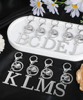 Custom Initial V Keychain In Stainless Steel Key Ring Silver Alphabet Charm For Women And Men on display with letters B through J.