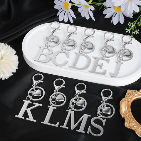 Custom Initial V Keychain In Stainless Steel Key Ring Silver Alphabet Charm For Women And Men on display with letters B through J.