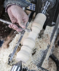 Rock Solid M2 High Speed Steel Spindle Gouge With Cryo Enhancement And Premium Beech Handle used in woodturning with shavings flying.