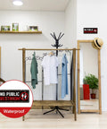 2 Pack No Public Restroom Signs Weatherproof Vinyl Stickers on a wall in a clothing store with wooden decor.
