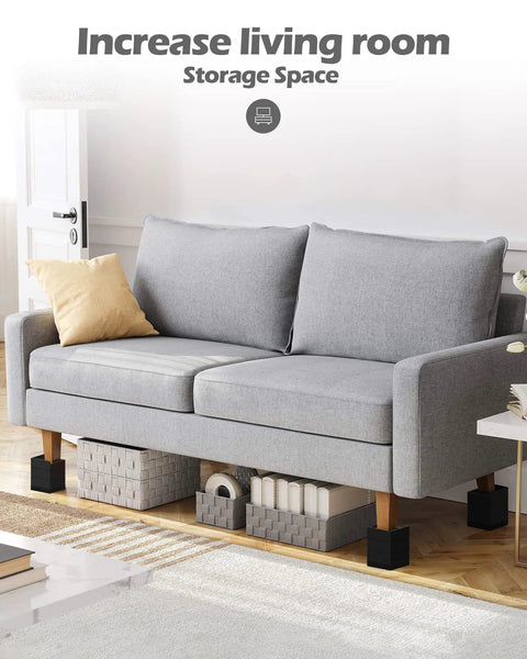 Give Your Bed Or Sofa A Legit Boost With These Heavy Duty Furniture Risers Featuring Adjustable Heights Anti Slip Grip Shock Absorbing Base And Rock Solid Support Handling Up To 1300 Lb Load In Sleek Black under a grey couch with storage bins.
