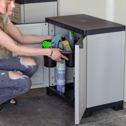 Person organizing supplies in Beast Of A Heavy Duty Freestanding Resin Garage Storage Cabinet With Adjustable Shelf In Gray, Real Space Saver For Laundry Room, Office Or Basement, 23.25 W X 13.75 D X 25.5 H, Sturdy Utility Organizer.