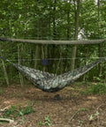 Snakeskin Tarp Sleeve 12ft Camping Rain Fly Storage Kit set up over hammock in forest, OD Green for hiking