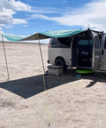 Van setup with tarp held by Adjustable Portable Tent Poles 74.8 Inches Beefy Rustproof Thickened Iron Stakes For Camping Hiking Van Awnings Beach Tents With Storage Bag 2 Pack Black