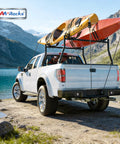 Heavy Duty Extending Steel Truck Bed Ladder Rack With Dual Kayak J Cradles And No Drill Z Clamps on white pickup truck by lake.