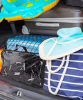 SUV trunk loaded with beach gear secured by Heavy Duty Truck Bed Cargo Net For Pickup And SUV, 4 By 3 Feet Stretching To 8 By 6