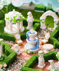 15 Pcs Mini Garden Furniture Ornaments Set For Do It Yourself Fairy Garden And Micro Landscape Decor Totally Durable Resin Patio Table Chair Bench Arch Fountain Statues Set in a garden scene