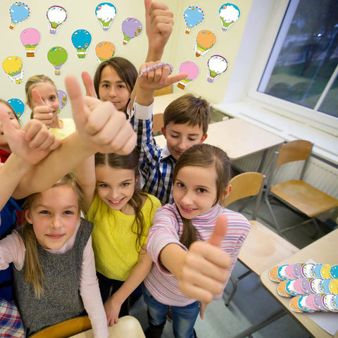 Group of children in classroom with Hot Air Balloon Sticky Notes Bulk Pack, 36 Packs In 9 Styles, 1080 Sheets Total on the wall