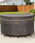 Heavy Duty Round Patio Table And Chair Cover 84 Inch Diameter 28 Inch High Waterproof UV Resistant Dark Grey Fits 84 Inch Tables Or 47 Inch Tables With Chairs Outdoor Weatherproof Protection showing installed on outdoor furniture