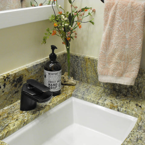 Waterfall Lav Faucet With Single Lever, Oil Rubbed Bronze Finish, Solid Brass Construction on granite countertop with soap