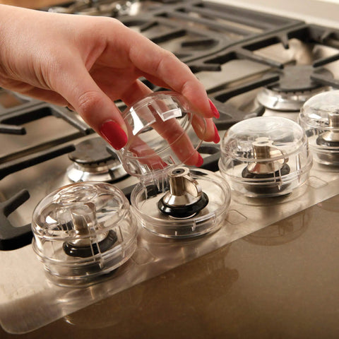 Stove And Oven Knob Safety Cover Set L730A Five Count Pack Easy To Install Kid Safe Kitchen Accessory Clear in use on stove.