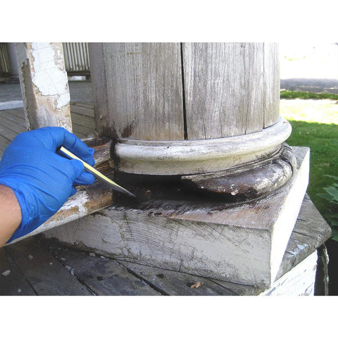 Applying LiquidWood 2 Pint Kit 2 Part Structural Epoxy Wood Hardener And Consolidant Resin to weathered wood column base