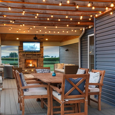 25 Foot G40 LED Outdoor String Lights With 11 Bulbs Plug In Waterproof Patio String Lights For Backyard Parties Dimmable Shatterproof Safe Design Black Finish Porch Balcony Decor hanging on a patio with outdoor seating and fireplace.